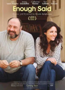 Two adults sitting together on a couch, smiling at the camera in a casual home setting