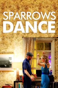 Two people dancing in a vintage-style living room with yellow wallpaper and warm lighting