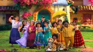 Animated family group standing together in front of colorful house with flowering vines, holding umbrellas and smiling at camera